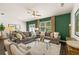 Spacious living room with two sofas and a green accent wall at 301 Sound Cir, Stockbridge, GA 30281