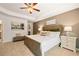 Spacious bedroom with a ceiling fan, beige carpet, and a walk-in closet at 301 Sound Cir, Stockbridge, GA 30281