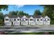 Exterior view of townhomes with white siding and gray roofs at 301 Sound Cir, Stockbridge, GA 30281