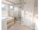 Bathroom with shower, tub, and updated fixtures at 335 Wilma Sw Ct, Atlanta, GA 30331