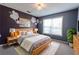 Main bedroom with wood bed frame and floral wall art at 335 Wilma Sw Ct, Atlanta, GA 30331