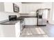 Kitchen with white cabinets, stainless steel appliances, and dark countertops at 335 Wilma Sw Ct, Atlanta, GA 30331