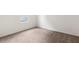 An empty bedroom with a carpeted floor, white walls, and a window at 3745 Newbury Place Dr, Loganville, GA 30052