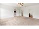 Large carpeted bedroom featuring doorways to the kitchen and ensuite bathroom at 3745 Newbury Place Dr, Loganville, GA 30052