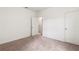 A bright, carpeted bedroom featuring a door leading to the bathroom at 3745 Newbury Place Dr, Loganville, GA 30052