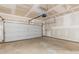 An unfinished garage with a white garage door and bare drywall at 3745 Newbury Place Dr, Loganville, GA 30052