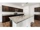 The large island is the focal point of this bright kitchen with granite counters and stainless appliances at 3745 Newbury Place Dr, Loganville, GA 30052