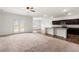 A bright living room featuring modern appliances and carpeted flooring at 3745 Newbury Place Dr, Loganville, GA 30052