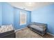 Blue Bedroom featuring a crib, changing table, carpet, and textured ceiling at 4405 Maple Valley Dr, Cumming, GA 30040