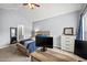 Bedroom featuring a carpeted floor, vaulted ceiling, and desk area in front of the window at 4405 Maple Valley Dr, Cumming, GA 30040