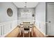 Traditional dining room boasting wainscoting, hardwood floors, and decorative 'Let's Eat' and 'Gather' wall decor at 4405 Maple Valley Dr, Cumming, GA 30040