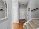 Inviting foyer with hardwood floors, neutral gray walls and a carpeted staircase leading to the upper level at 4405 Maple Valley Dr, Cumming, GA 30040