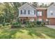 A lovely townhome with brick and siding, a well-manicured lawn, and lush greenery at 4405 Maple Valley Dr, Cumming, GA 30040