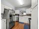 Functional kitchen featuring stainless steel appliances, white cabinets, and a mosaic backsplash at 4405 Maple Valley Dr, Cumming, GA 30040