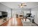 Bright living room with hardwood floors, a cozy fireplace, and french doors leading to the outdoor space at 4405 Maple Valley Dr, Cumming, GA 30040