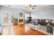 Inviting living room with hardwood floors, a fireplace, french doors, and a comfortable gray sectional sofa at 4405 Maple Valley Dr, Cumming, GA 30040