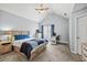 Cozy main bedroom featuring a vaulted ceiling, carpeted floor, and complementary blue accents at 4405 Maple Valley Dr, Cumming, GA 30040