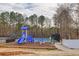 Bright blue and green playground and fenced tennis court in a community park at 4405 Maple Valley Dr, Cumming, GA 30040