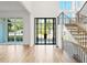 Bright foyer with hardwood floors, staircase with metal railings, and large windows for natural light at 3661 Clubwood Trl, Marietta, GA 30068
