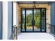 Front door with black metal grid, sidelights, transom window, stone surround, and painted porch at 3661 Clubwood Trl, Marietta, GA 30068