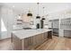 Spacious kitchen featuring a large island, white cabinets, stainless steel appliances, and hardwood flooring at 3661 Clubwood Trl, Marietta, GA 30068