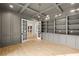 Home office with built-in bookshelves, cabinets, coffered ceiling, French doors, and hardwood floors at 3661 Clubwood Trl, Marietta, GA 30068