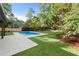Backyard with a swimming pool, patio area, lush lawn, and mature trees for privacy at 3661 Clubwood Trl, Marietta, GA 30068
