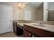 Bathroom featuring a double vanity with granite countertops and wood cabinetry at 4805 West Village Way # 3207, Smyrna, GA 30080