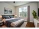 Comfortable bedroom with a large window, wood floor and stylish furnishings at 4805 West Village Way # 3207, Smyrna, GA 30080