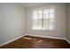 Bright bedroom with natural light shining through the window, highlighting the hardwood floors at 4805 West Village Way # 3207, Smyrna, GA 30080