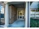 Close-up view of condo building entrance with brick pillars and accessible entrance at 4805 West Village Way # 3207, Smyrna, GA 30080