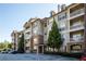 Exterior view of condo building with parking lot and surrounding landscaping at 4805 West Village Way # 3207, Smyrna, GA 30080