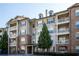 Exterior view of condo building with brick accents, neutral siding, and multiple balconies at 4805 West Village Way # 3207, Smyrna, GA 30080