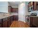 Kitchen with stainless steel appliances, dark cabinets, and tile backsplash at 4805 West Village Way # 3207, Smyrna, GA 30080