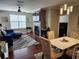 Inviting living room with a cozy fireplace and a stylish dining area bathed in natural light at 4805 West Village Way # 3207, Smyrna, GA 30080