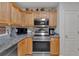 Modern kitchen with stainless steel appliances and wood cabinets at 49 Ne Kay Rd, White, GA 30184