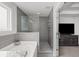 Modern main bathroom with gray tile, glass shower, soaking tub and vanity at 679 Mcwilliams Se Rd, Atlanta, GA 30315