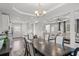 Open concept dining room connecting kitchen and living room with elegant lighting and coffered ceilings at 679 Mcwilliams Se Rd, Atlanta, GA 30315