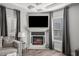 Living room with a modern fireplace, recessed lighting, and custom window treatments at 679 Mcwilliams Se Rd, Atlanta, GA 30315