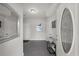 Bright foyer with gray plank flooring, stylish decor, and a front door with decorative glass insert at 679 Mcwilliams Se Rd, Atlanta, GA 30315