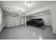 Spacious three-car garage with sealed concrete flooring, overhead lighting and automatic door openers at 679 Mcwilliams Se Rd, Atlanta, GA 30315