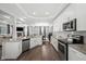 Open concept kitchen flowing into living and dining area with stainless steel appliances and granite countertops at 679 Mcwilliams Se Rd, Atlanta, GA 30315