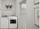Laundry room with white washer and dryer near a bright window at 679 Mcwilliams Se Rd, Atlanta, GA 30315