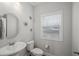 Powder room featuring modern vanity, toilet, and a round mirror at 679 Mcwilliams Se Rd, Atlanta, GA 30315