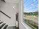 View of the staircase with dark steps, white risers, and a large window overlooking the neighborhood at 679 Mcwilliams Se Rd, Atlanta, GA 30315