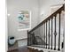 Elegant staircase with decorative iron spindles, wooden handrail and a window for natural light at 679 Mcwilliams Se Rd, Atlanta, GA 30315