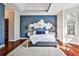 Main bedroom with a dark accent wall, hardwood floors, and natural light from the windows at 7775 Georgetown Chase, Roswell, GA 30075