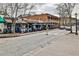 Street view of restaurant, with tables seated outdoors on a sunny day at 7775 Georgetown Chase, Roswell, GA 30075