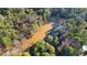 Scenic aerial view shows a charming pond surrounded by dense trees, a perfect spot for nature enthusiasts at 550 S Rays Rd, Stone Mountain, GA 30083