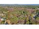 Scenic aerial view of wooded acreage with a pond near a residential neighborhood at 550 S Rays Rd, Stone Mountain, GA 30083
